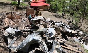 A Kashmiri resident inspecting a house